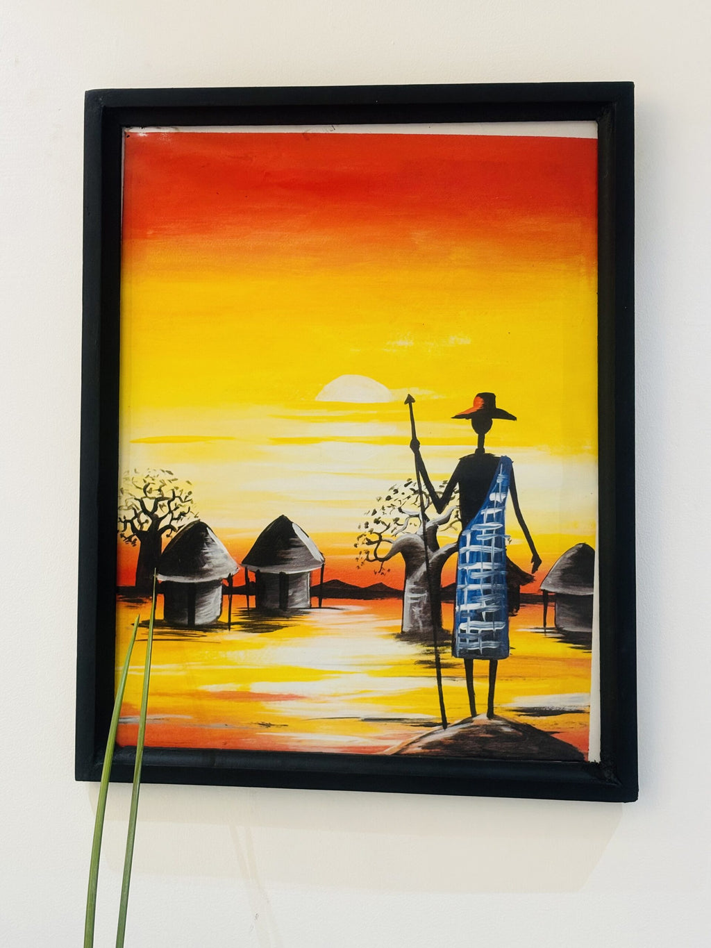Man with Spear in Front of Huts and Sunrise