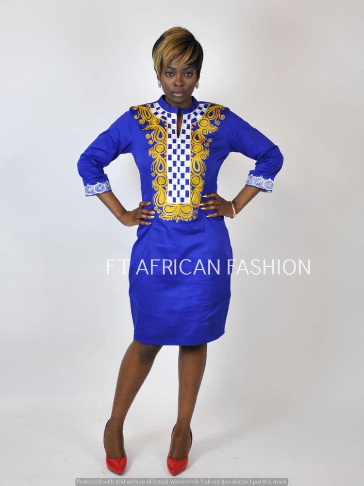 Frontal of model wearing a blue pencil dress with gold African embroidery detail and checker print on the front.