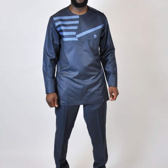 Frontal of model wearing a men's solid dark blue authentic, traditional men's African suit with striped embroidery detail on the chest.