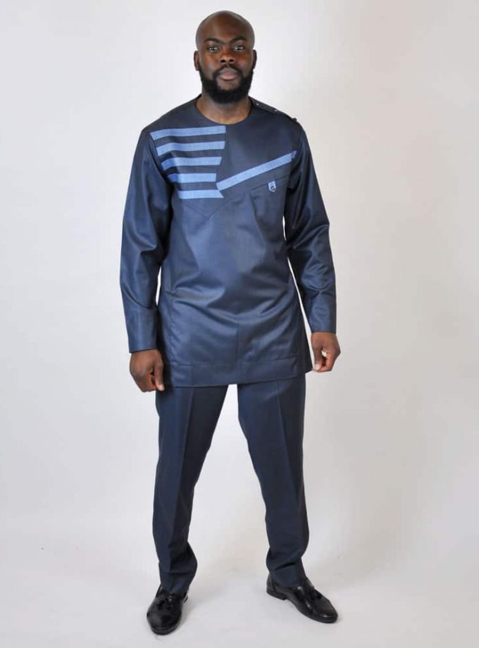 Frontal of model wearing a men's solid dark blue authentic, traditional men's African suit with striped embroidery detail on the chest.
