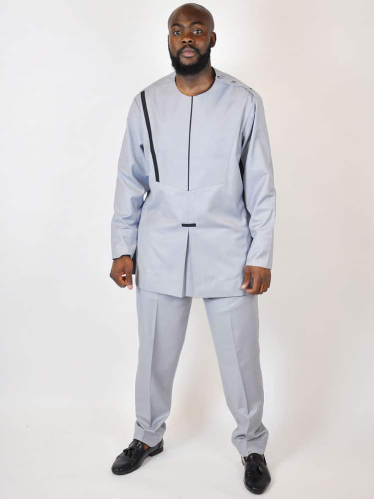 Frontal of model wearing our Wole men's African embroidered senator suit in pale blue. Features a simple embroidery pattern on the front.