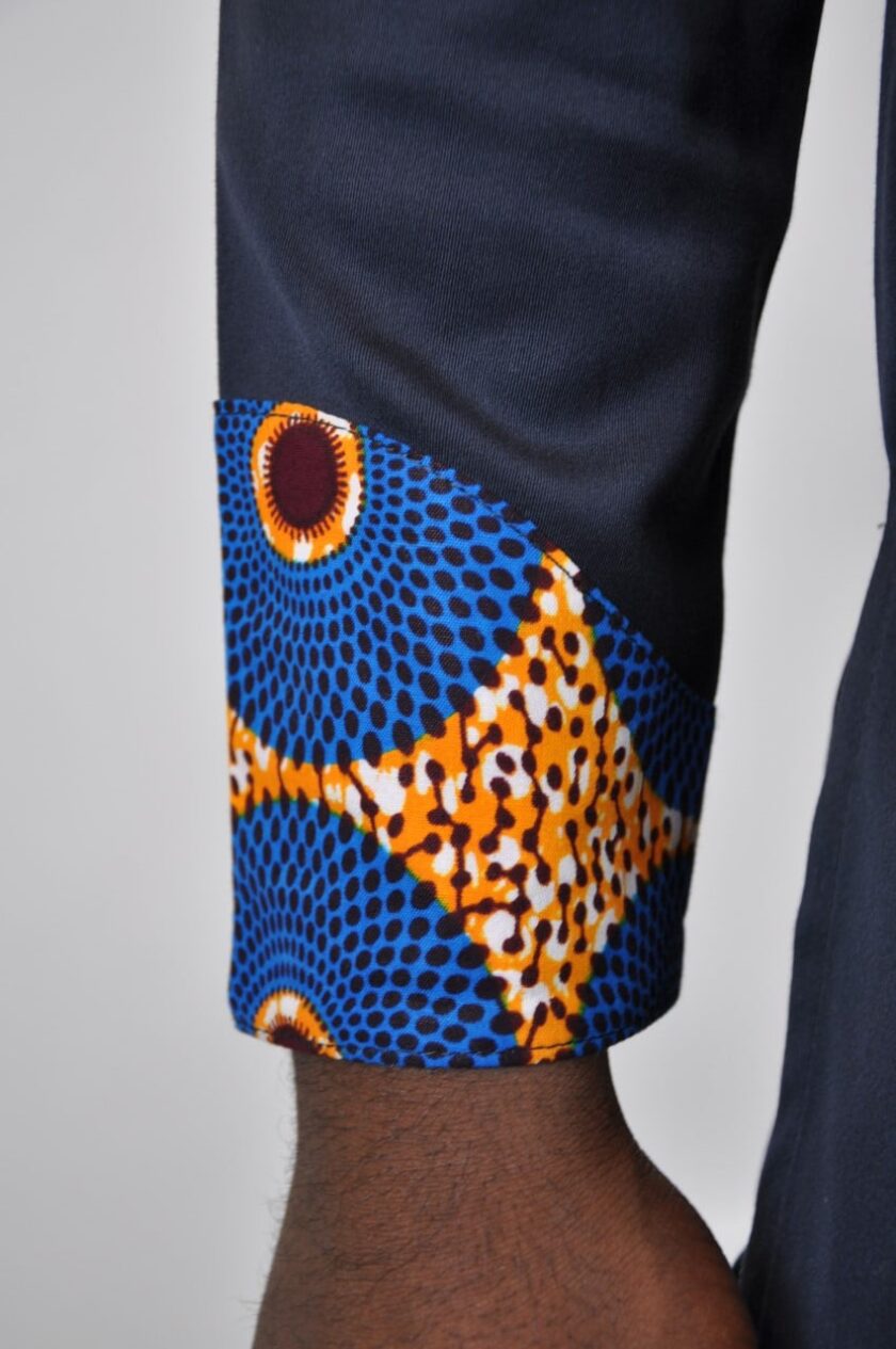 Close shot of Subra African print detail on the cuffs for this men's dark blue-black shirt with stand collar.