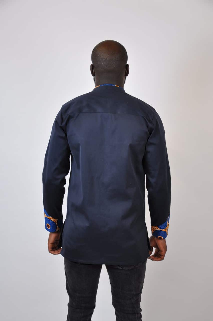 Back shot of model wearing a men's dark blue-black shirt with stand collar.