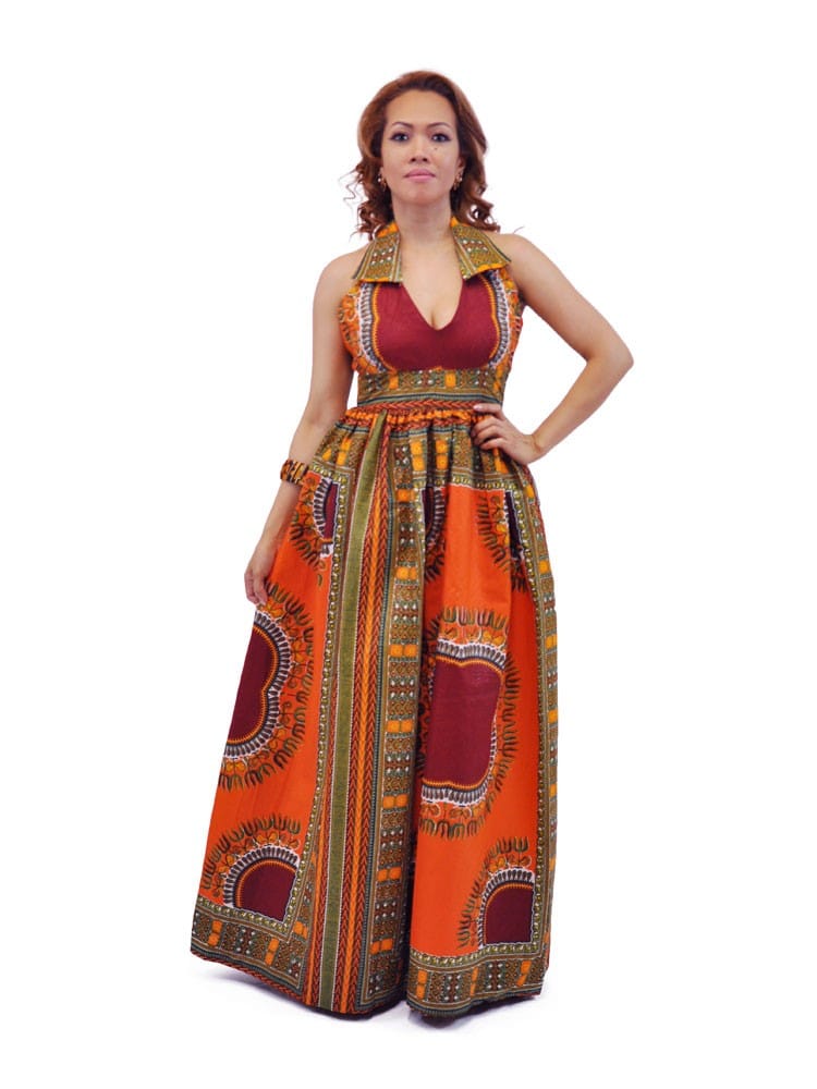 Frontal of model wearing a deep orange and red floor-length dress with all over multi-coloured African dashiki print.