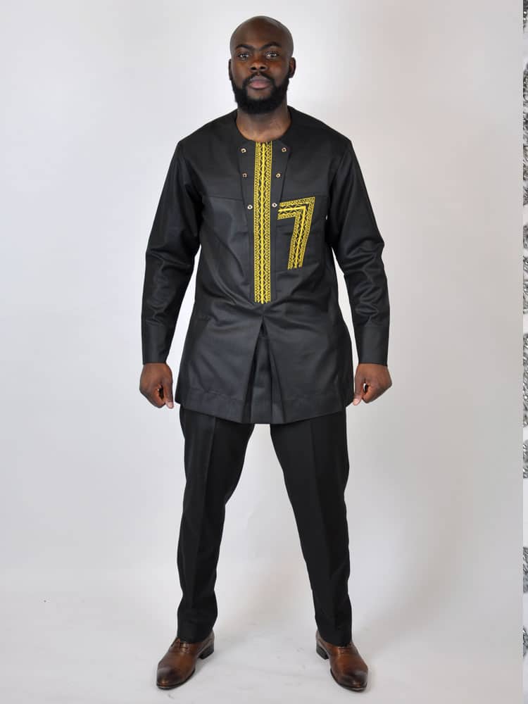 Full frontal of model wearing a men's black traditional African suit with gold embroidery on the chest.