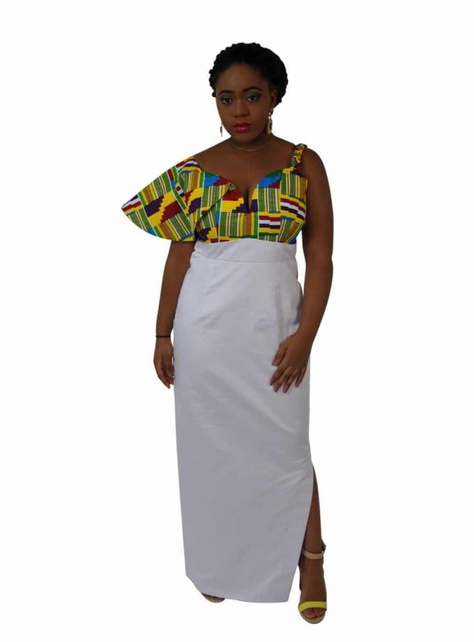 Frontal of model wearing a white African inspired asymmetrical fusion dress with Kente print detail on the bodice and right sleeve.