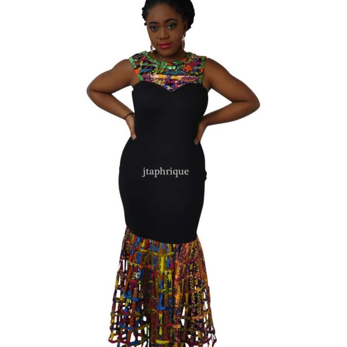 Frontal of model wearing a black bodycon dress with multi-coloured African Ankara mesh illusion detail on the sweetheart neckline and flared hem.