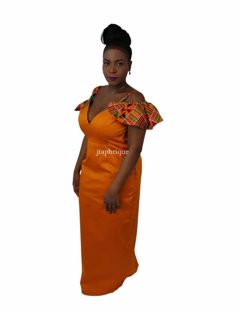 Frontal of model wearing a solid orange cold shoulder occasion dress with African Kente print ruffle detail on the sleeves.