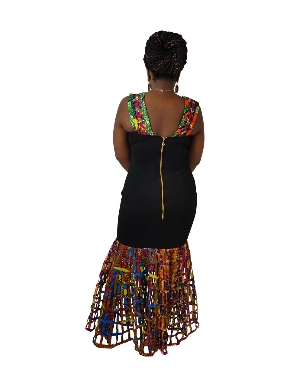Back shot of model wearing a black bodycon dress with multi-coloured African Ankara mesh illusion detail on the sweetheart neckline and flared hem..