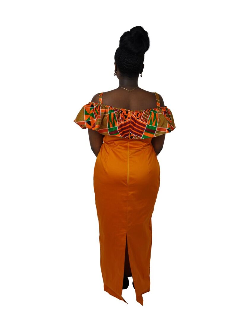 Back shot of model wearing a solid orange cold shoulder occasion dress with African Kente print ruffle detail on the sleeves and rear neckline.