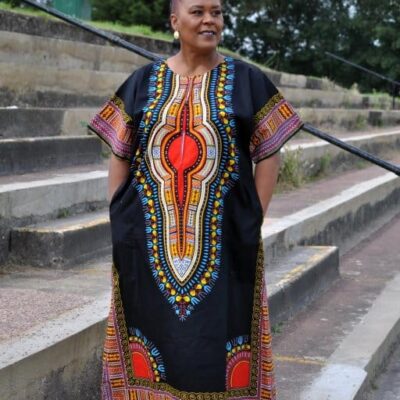 Full frontal of model wearing a black & multi-coloured dashiki print kaftan dress in maxi length.