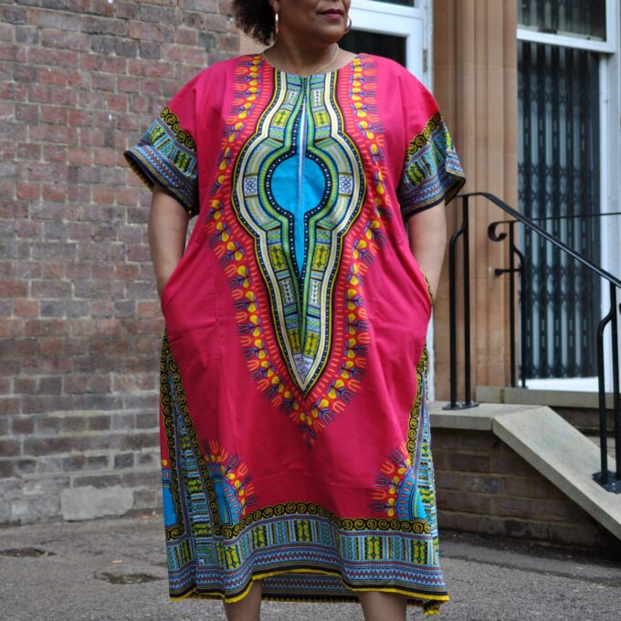 Frontal of model wearing our Dashiki Kaftan Zip Front Maxi Dress in pink. Features Angelina dashiki pattern.