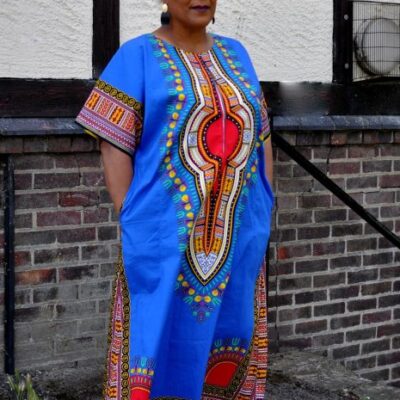 Full frontal of model wearing this dress in bright blue & multi-coloured print.