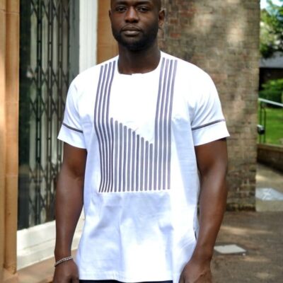 Frontal of model wearing a white short sleeved traditional African shirt with ash grey striped embroidery on front and sleeves.