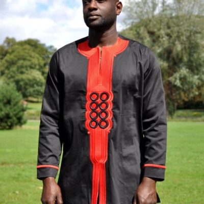 Frontal of model wearing our men's traditional African black shirt with red embroidery detail on the front and sleeves.
