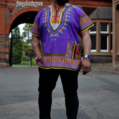 Full frontal of model wearing a men's purple traditional African shirt with Angelina dashiki pattern.