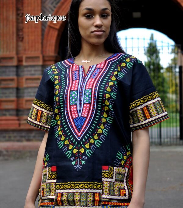 Close frontal of model wearing a ladies black traditional African Dashiki shirt with pink and multi-coloured Angelina print pattern on chest, sleeves and hem.