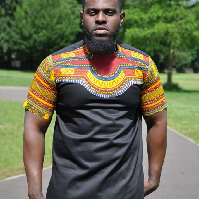 Close frontal of model wearing our Kwado African-inspired shirt designed with colourful Angelina Dashiki print pattern on the upper chest, neckline and sleeves.