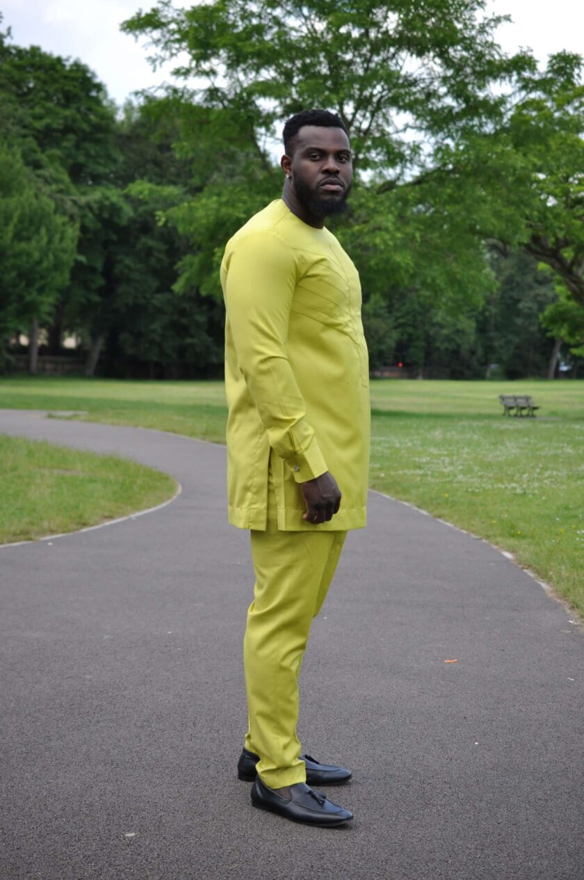 Side shot of model wearing an African trouser suit in solid Chartreuse yellow.