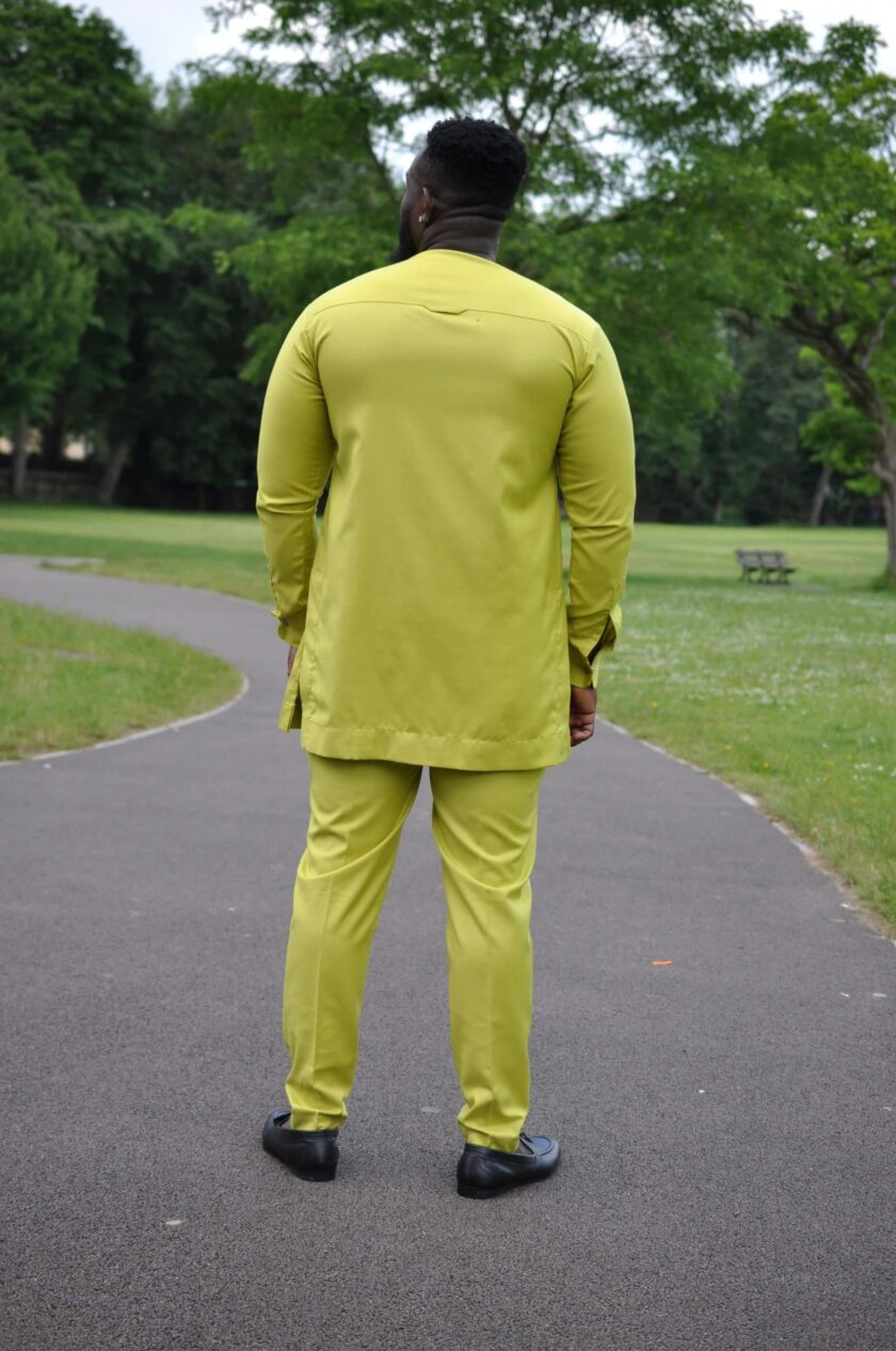 Full back shot of model wearing an African trouser suit in solid Chartreuse yellow.
