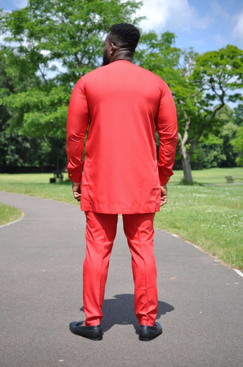 Back shot of model wearing a solid red custom made men's African suit.