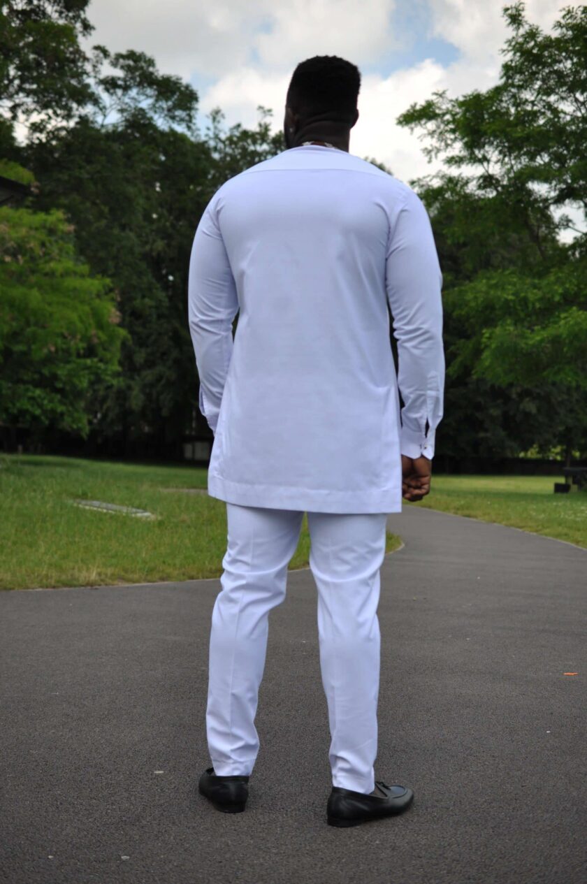 Full shot of model showing the back of our solid white custom made men's African suit.