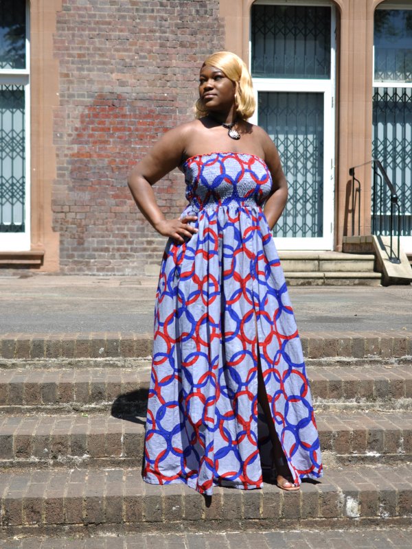 Full frontal of model wearing our blue Kosi bandeau maxi dress in all over circle or ring print. Features a shirred bust and front slit from left knee.