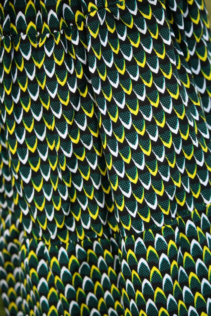 Close up of the African print fabric showing the subtle geometric pattern in yellow and white
