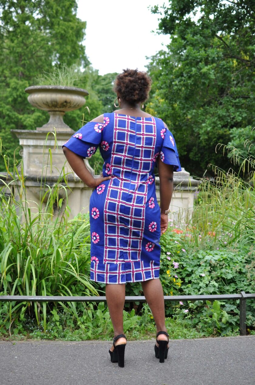 Back shot of model wearing our custom made African midi dress with a mixed geometric pattern.