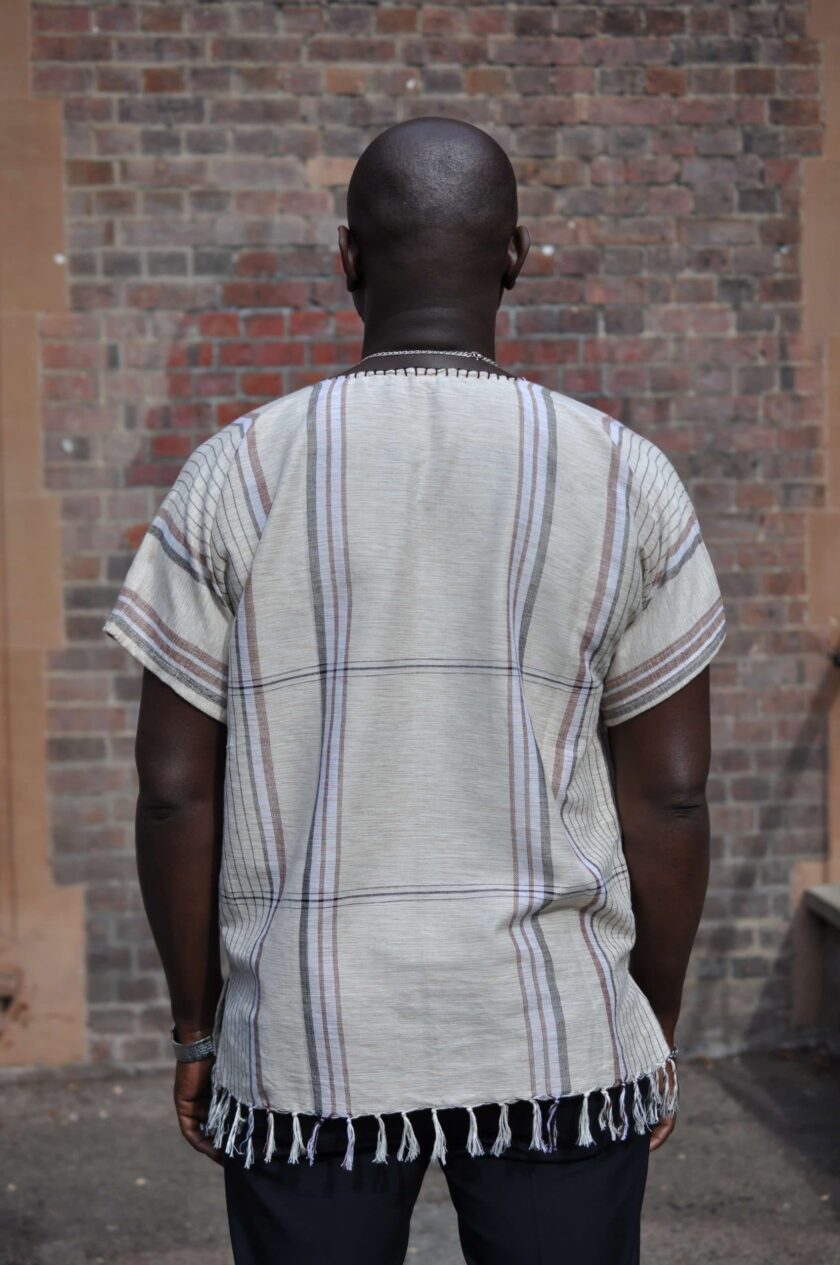 Back shot of model showing the large plaid pattern on this African Rhino tassel hem boho shirt