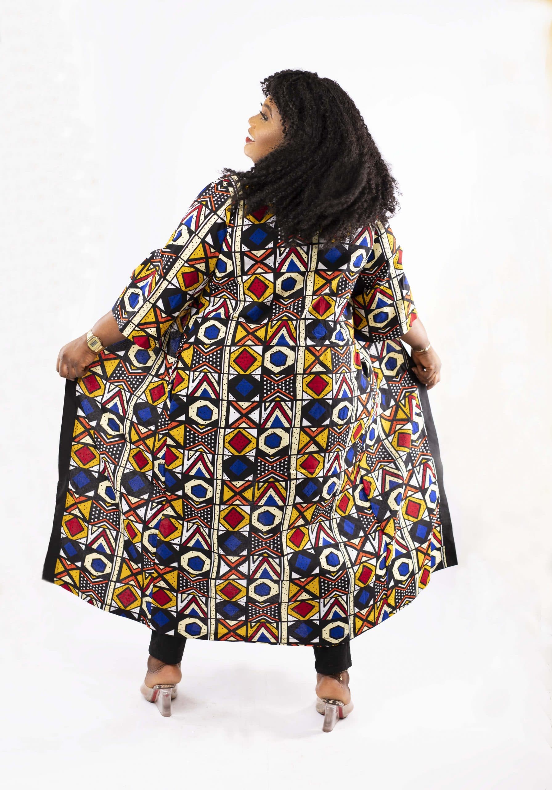 Back shot of model wearing a fabulous plus size ladies kimono coat in all over African Ankara print.