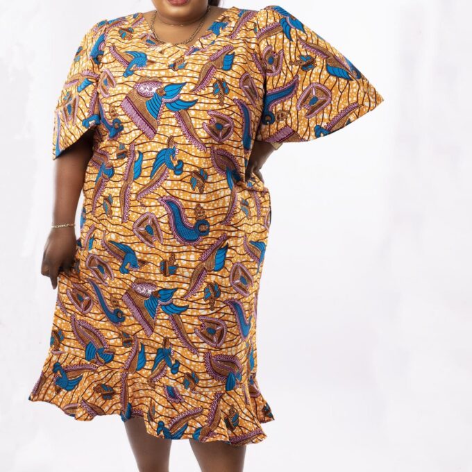 Frontal of model wearing a plus size gold and blue midi dress in all over African print.