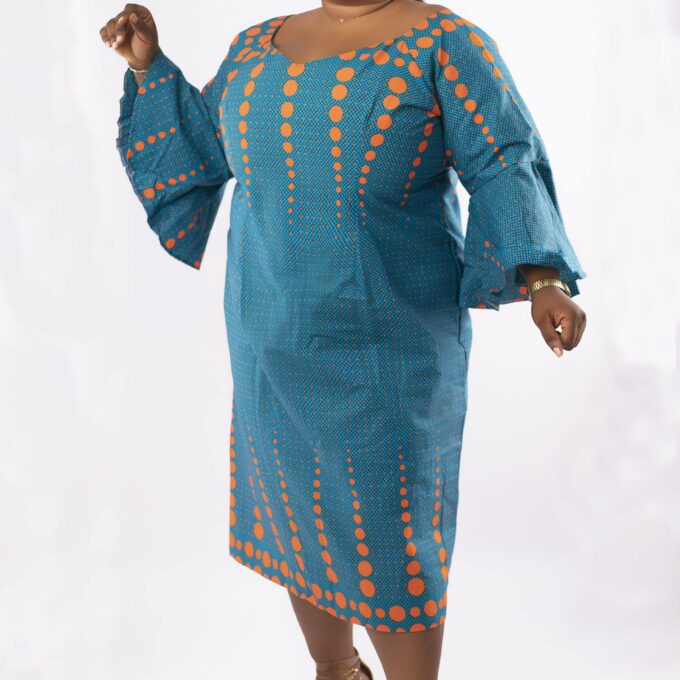 Frontal of model wearing a plus size occasion dress in all over African Ankara print.