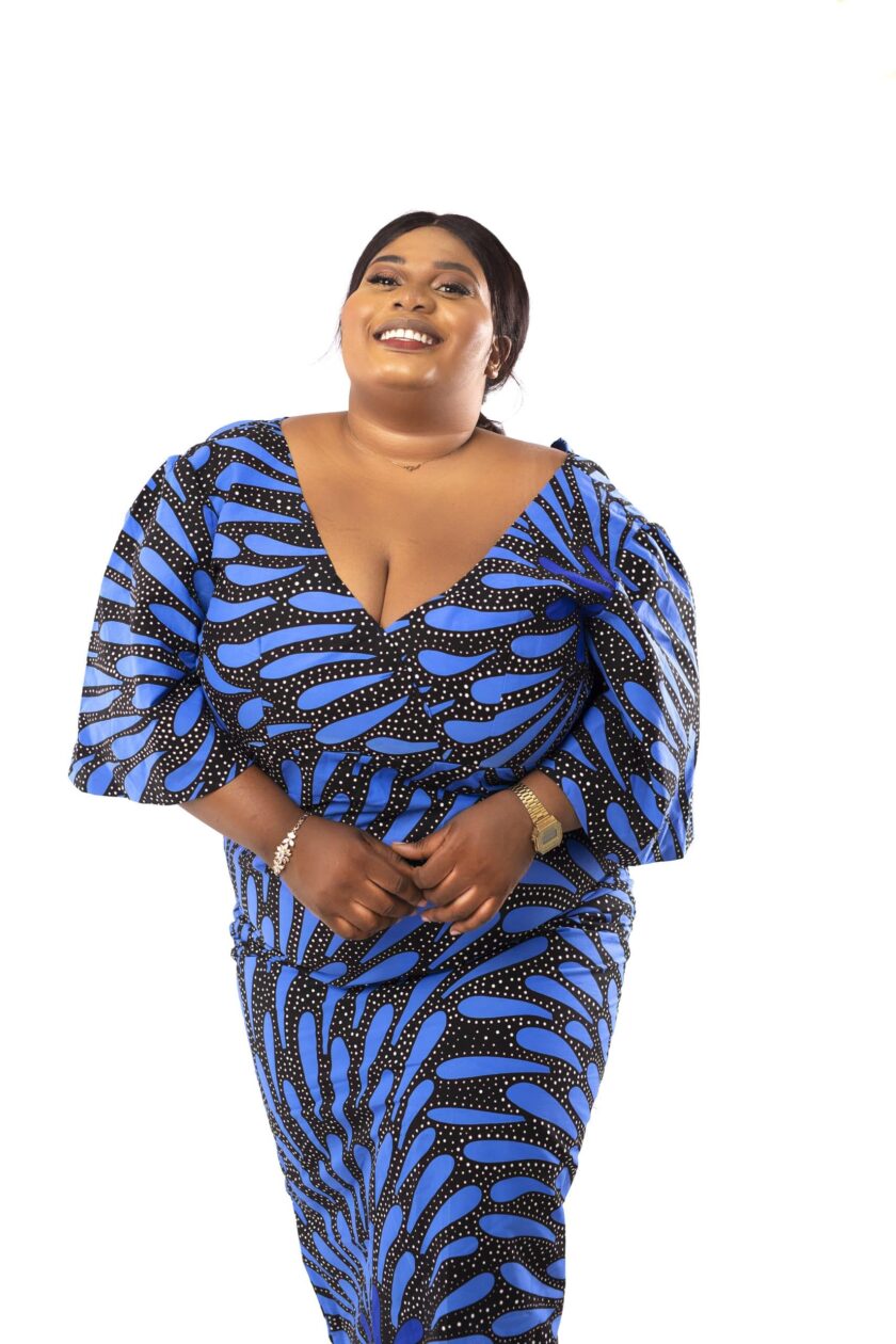 Frontal of model wearing a blue plus size bodycon maxi dress in all over black graphic African print