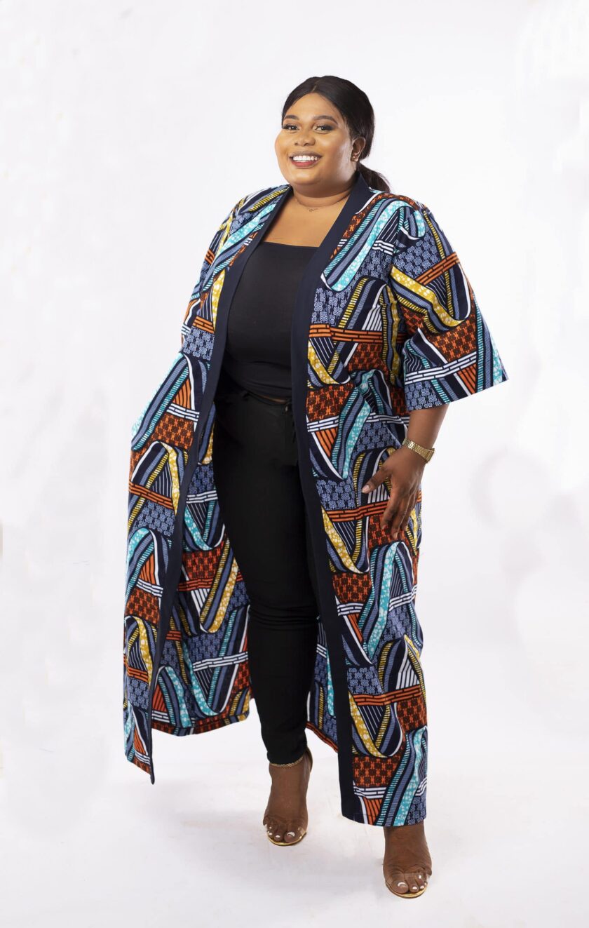 Frontal of model wearing a plus size kimono coat or jacket in all over African Ankara print.