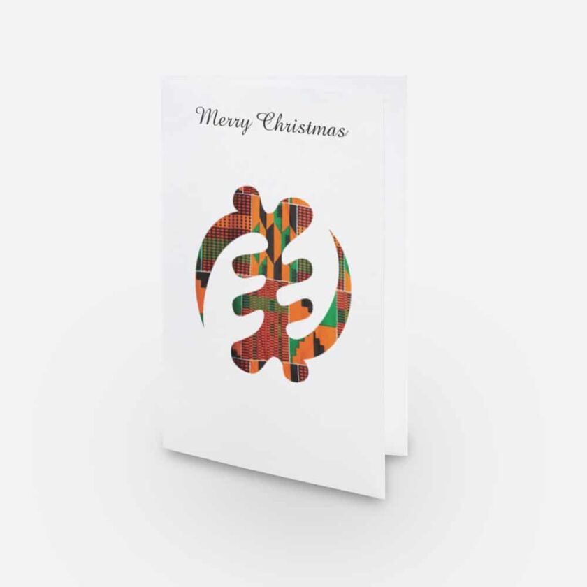 Shot of "Merry Christmas" greeting card featuring the Gye Nyame, Adinkra symbol decorated with multi-coloured African Kente print pattern.
