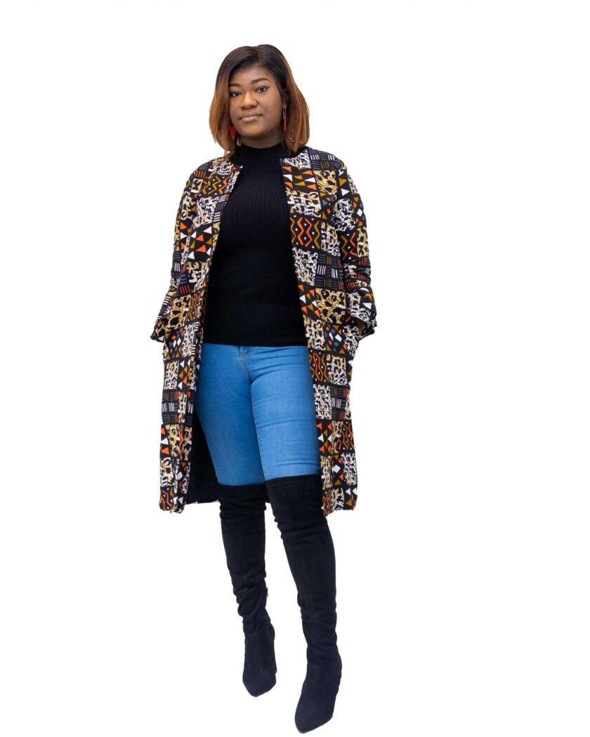 Frontal of model wearing a midi length ladies coat with round neck and all over African patchwork print in orange blue and multi-coloured.