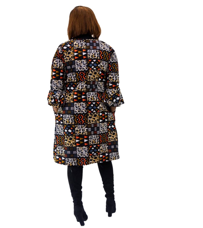 Back shot of model wearing a midi length ladies coat with round neck and all over African patchwork print in orange blue and multi-coloured.