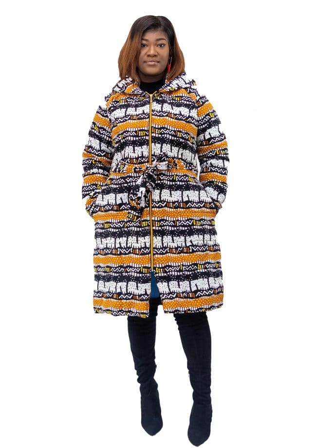 Frontal of model wearing a ladies hooded coat in all over horizontal African print pattern in gold, white and black.