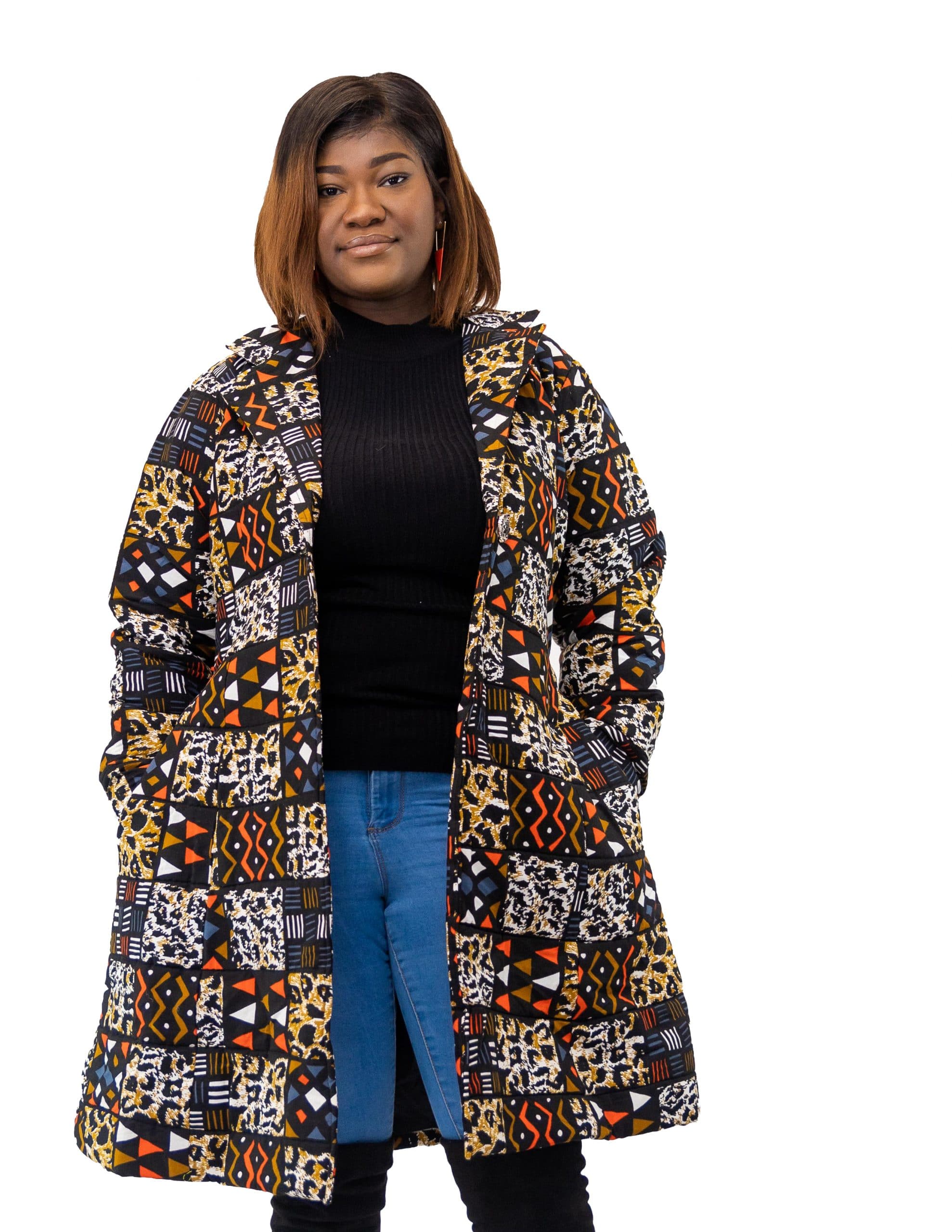 Full frontal of model wearing a medium length blue and orange multi-coloured African patchwork print coat.