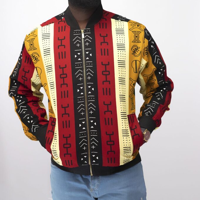 Frontal of model wearing our men's Kimani bomber jacket in all over colourful, striped, African Kente print pattern. Perfect for a festival!