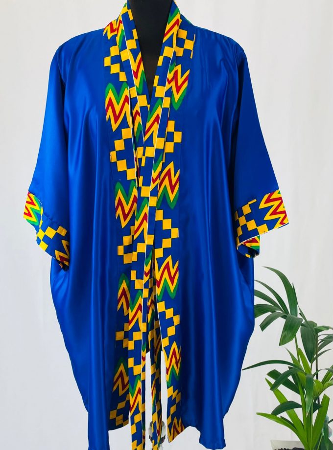Frontal of a blue satin robe with colourful African print on the sleeve cuffs, neckline and opening.
