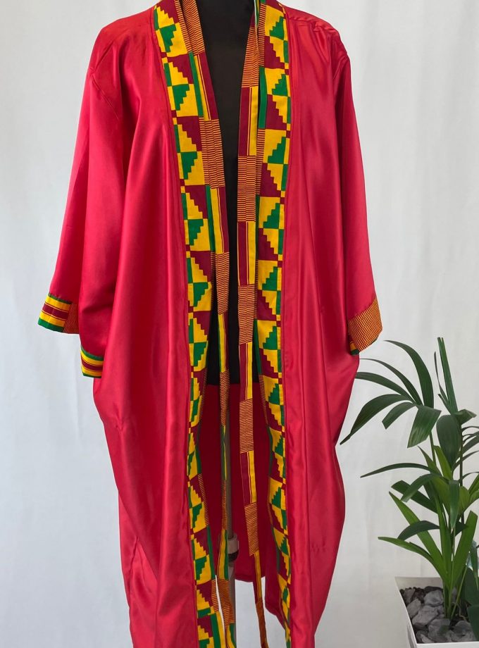 Front shot of a red satin robe with colourful African print on the sleeve cuffs, neckline and opening.
