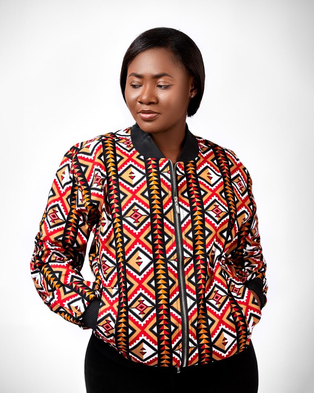 Frontal of model wearing a ladies bomber jacket in all over African print.