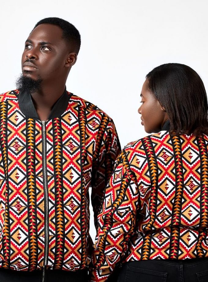 Shot of models wearing unisex African inspired bomber jackets in striped and geometric print pattern.