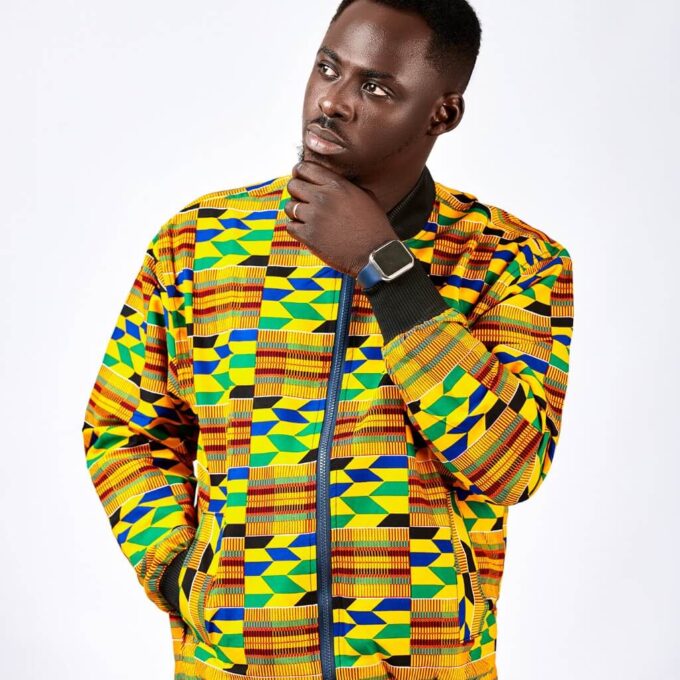 Frontal of model wearing our men's Deja Bomber Jacket in all over colourful / multi-coloured African Kente Print pattern.
