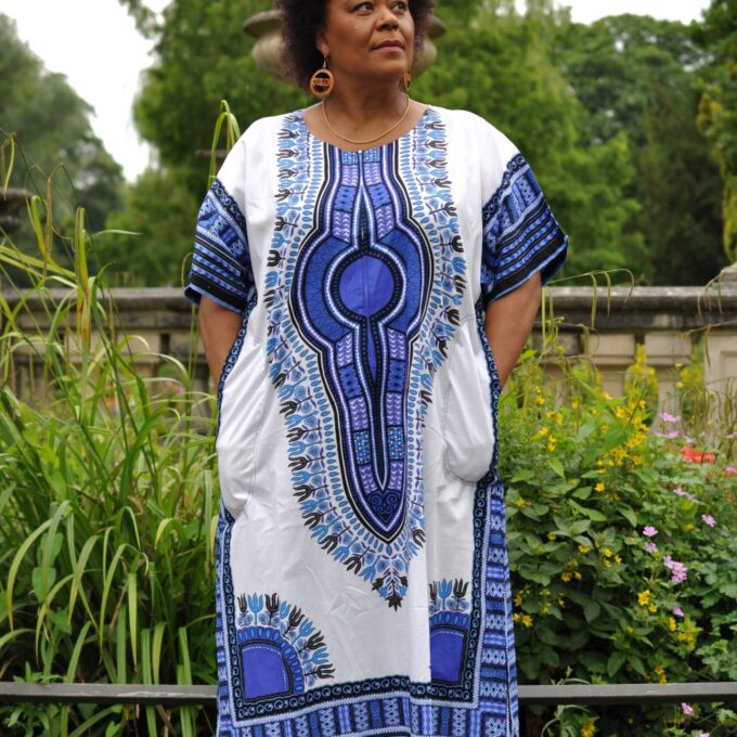 Frontal of model wearing our Dashiki Kaftan Zip Front Maxi Dress in white and blue. Features Angelina dashiki pattern.