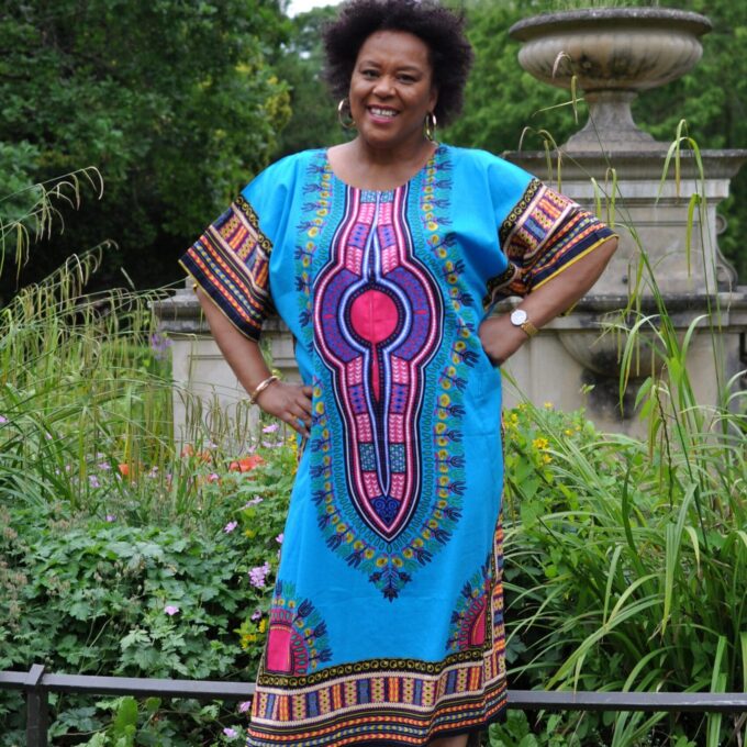 Frontal of model wearing our Dashiki Kaftan Zip Front Maxi Dress in turquoise blue. Features Angelina dashiki pattern.