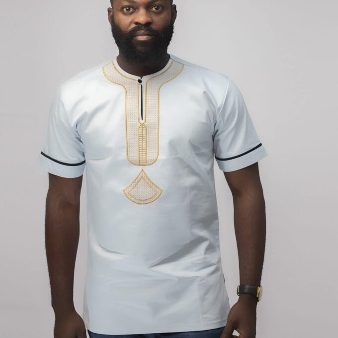Frontal of model wearing our Mamello Slim Fit Embroidered African Shirt in off-white or pale blue with abstract gold embroidery.