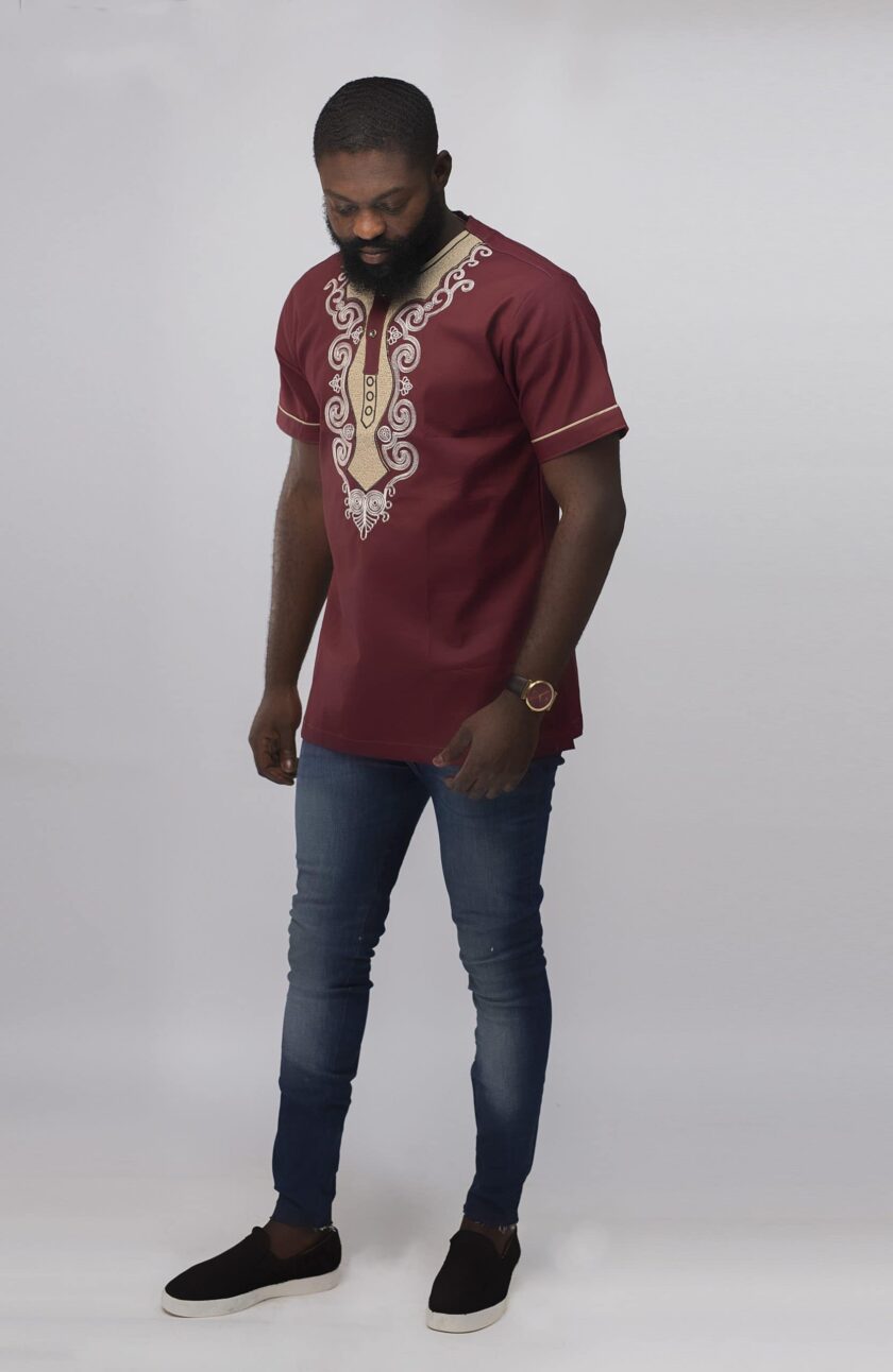 Frontal of model wearing our Muenda Slim Fit Embroidered African Shirt in burgundy / deep red / wine with cream and light pink elaborate embroidery pattern on the neckline, chest and sleeves.